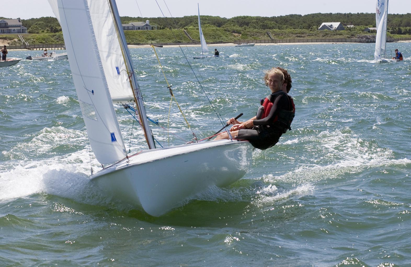 Sailboat and sailor cut through the waves. Mark Alan Lovewell