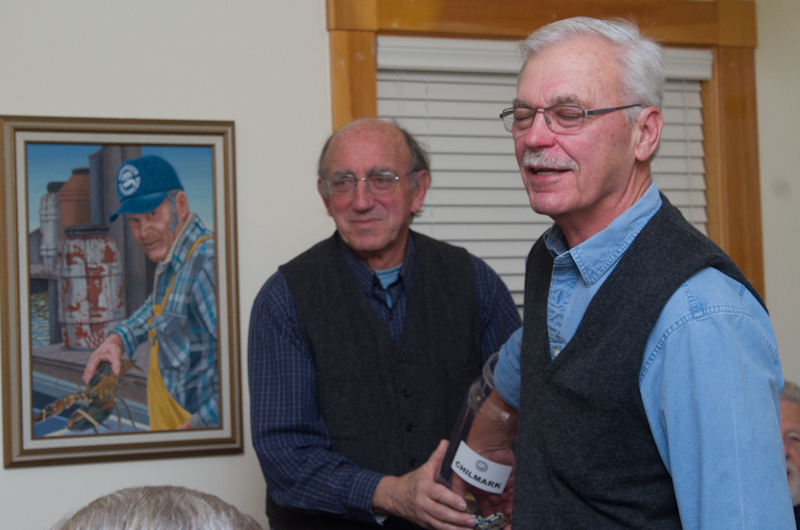 Selectman Warren Doty assists as former Chilmark selectman Frank Fenner draws numbers for the housing lots.