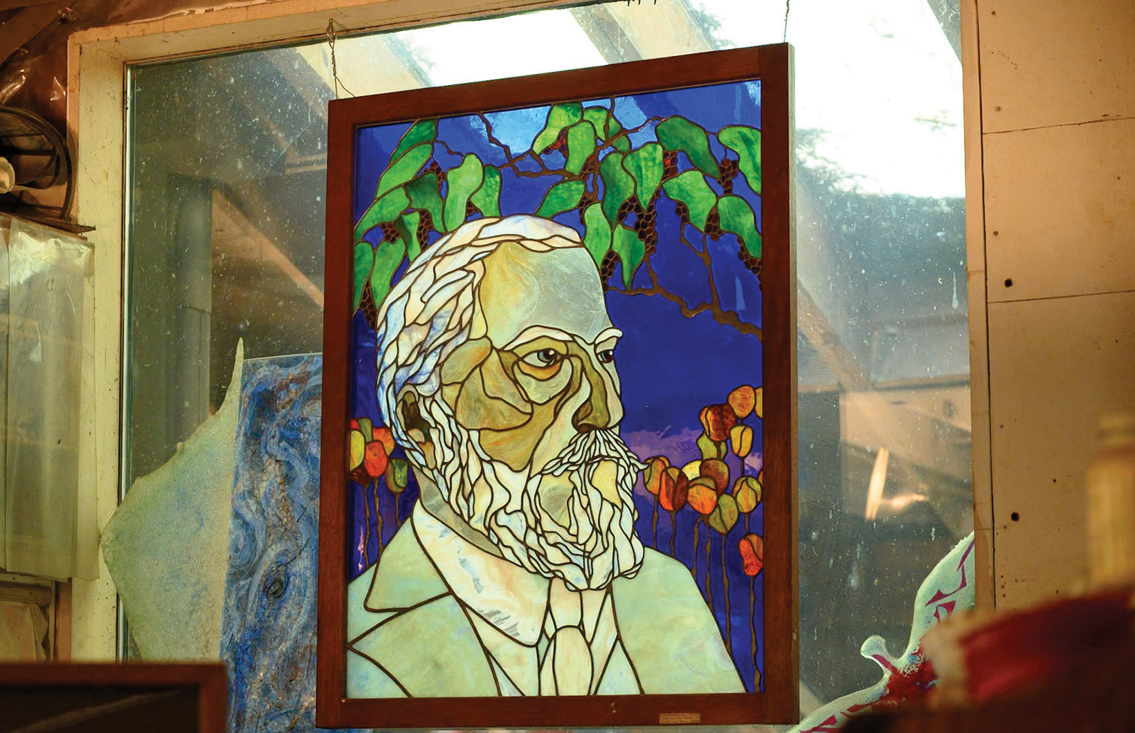 Works in leaded stained glass fill the studio with color.