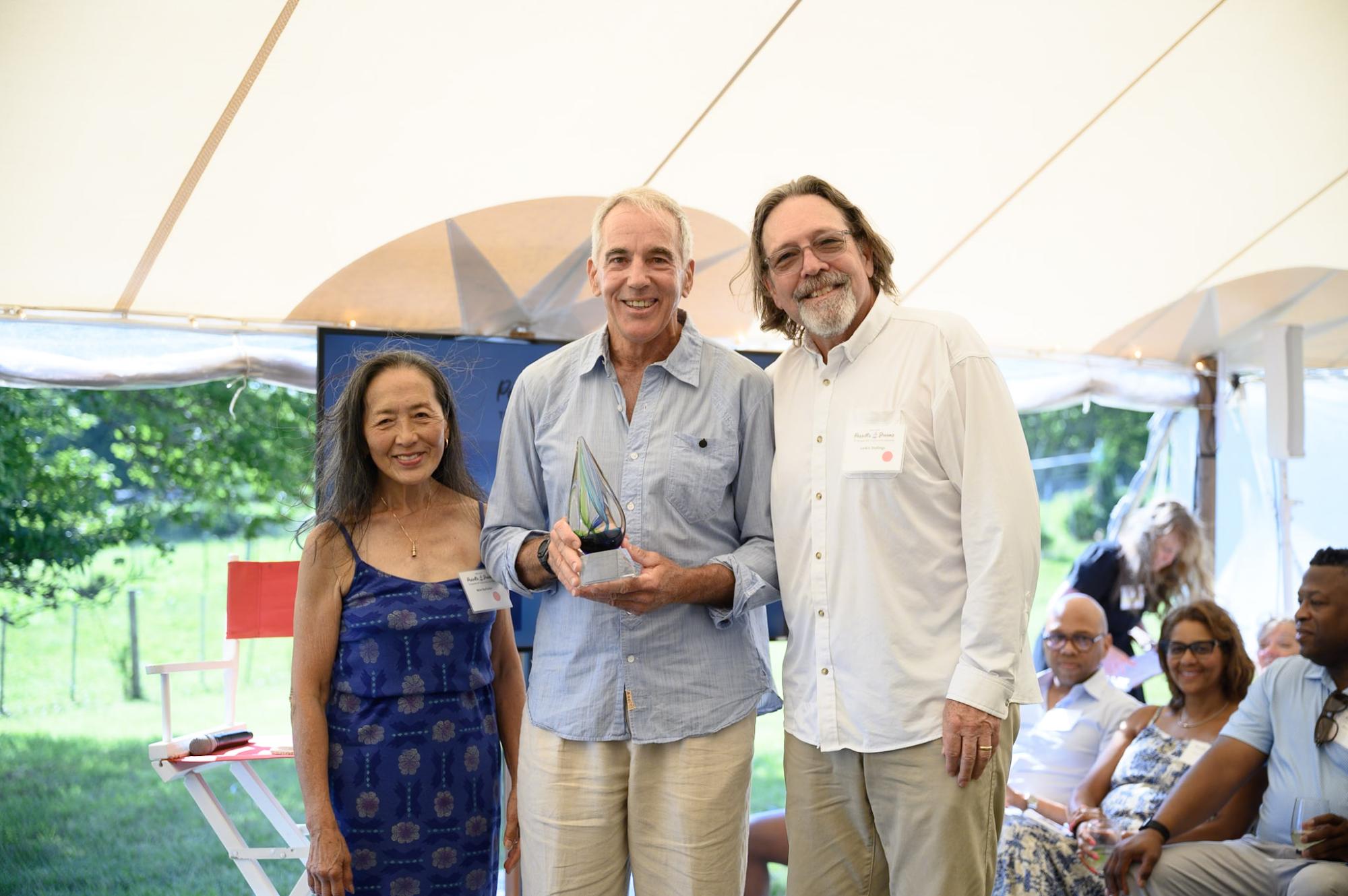 Wiet Bacheller and Larkin Stallings flank Art Buchwald Award winner Nevin Sayre.