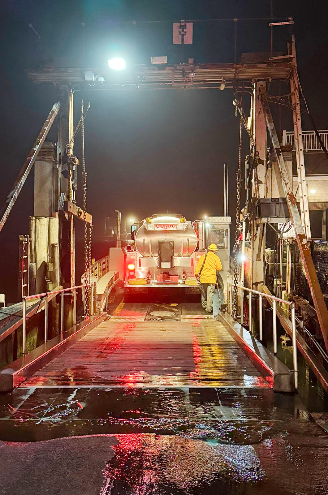A fire truck traverses the channel aboard the Chappy Ferry.