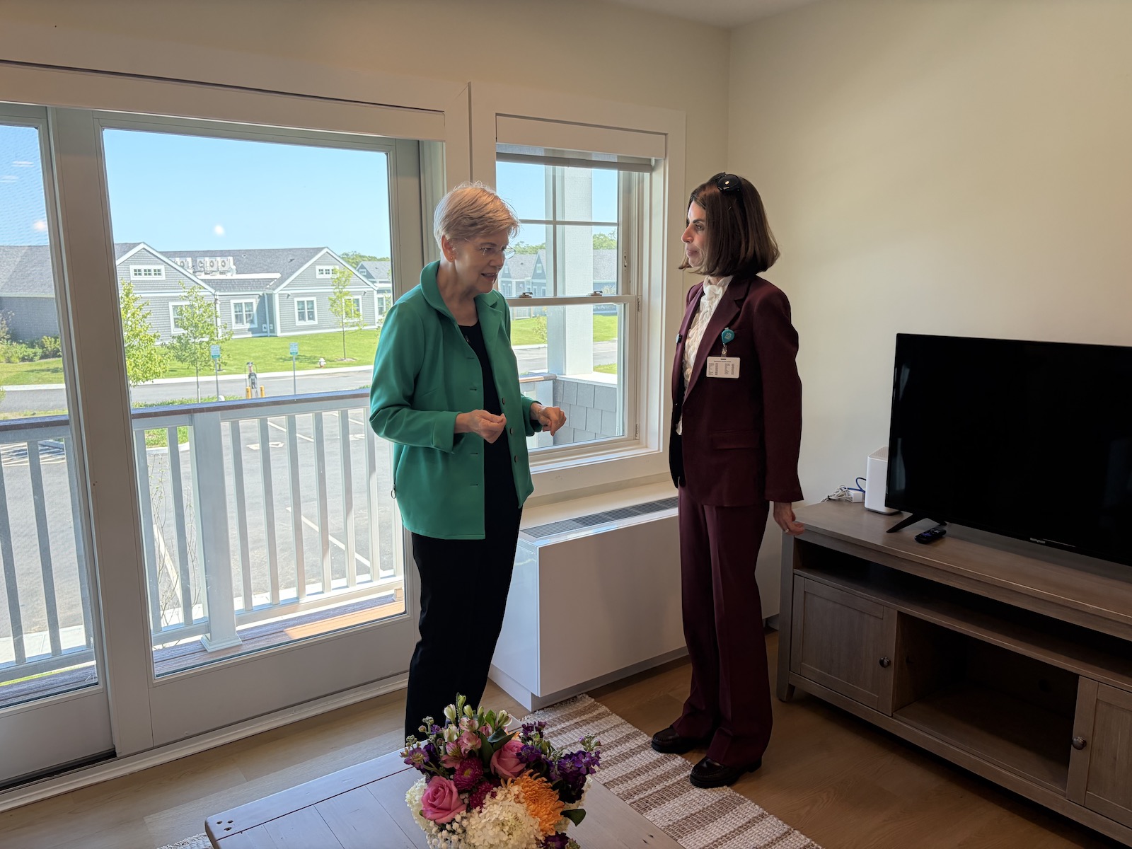 Elizabeth Warren tours Navigator Homes with hospital president Claire Seguin.