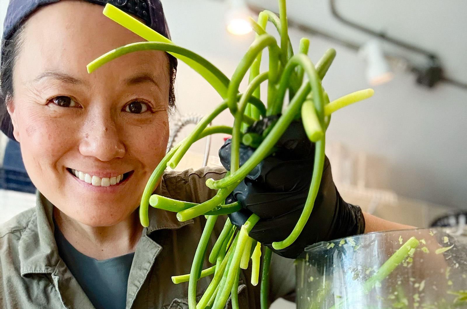 Ms. Wong working with garlic scapes at North Tabor Farm.