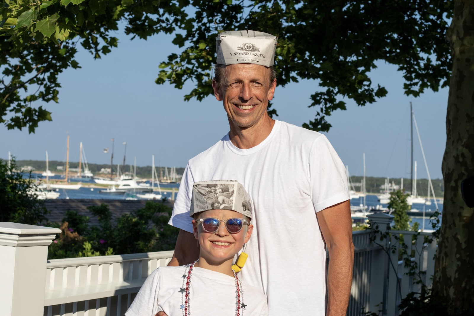 Seth Meyers and son are feeling good, decked out in Vineyard Gazette hats.
