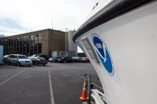 Shoreside fsheries office parking lot includes boats.