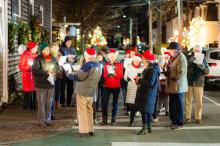 Members of the Federated Church congregation singing Christmas carols on the corner of Main street and Summer street.