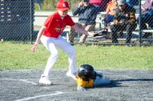 Pitcher Peter Rosbeck applies the tag to Jason Kornalski at home plate.