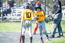 Cruz Cancellare and Jason Kornalski celebrating a run.