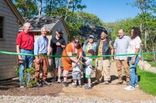 Organizers along with some of the new tenants cut the ribbon.