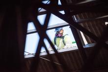 Worker is seen through hole upper-level roof.