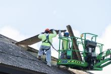 More tiles are loaded into lift from upper roof.