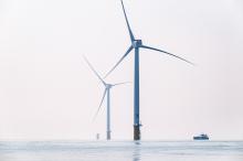 Row of turbines with security vessel.