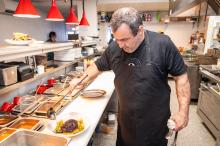 Chef Johnny Hoffman plating black rice at 9 Craft.