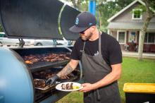 Tyler Potter of The Swimming Pig making barbecue.