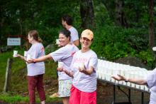 Volunteers hand out water for the runners.