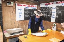 Mike Cassidy occupying his usual position as weigh-master.