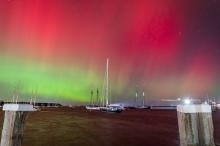 Tall ships in Vineyard Haven harbor under the northern lights.