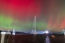 Steamship ferry entering under the Aurora Borealis.