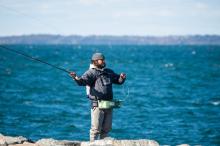Abe Pieciak fly fishing on the Aquinnah side of the jetty.