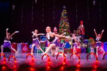 Ice skaters cut patterns across the stage.