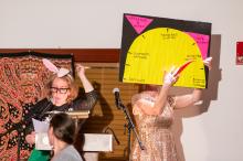 Molly Coogan and Abby Bender demonstrating the Applause-O-Meter.