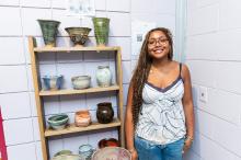 Leelyn Thompson next to her ceramic work.