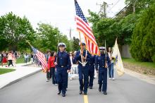 An honor guard leads the way.