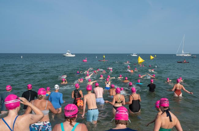 Swimmers make their way out from Menemsha beach.