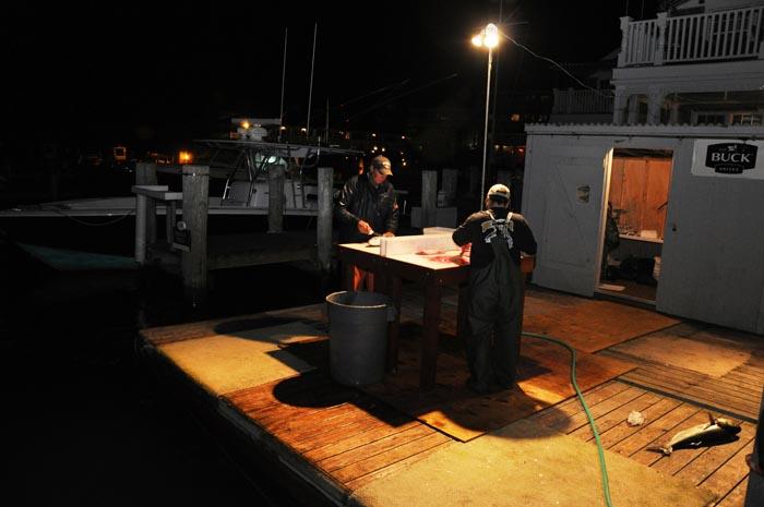 dock fishermen night time filleting station