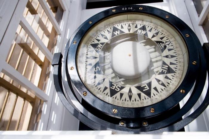 The Morgan's compass is visible through a skylight in front of the wheel. The Morgan visited every ocean in the world during her whaling years.