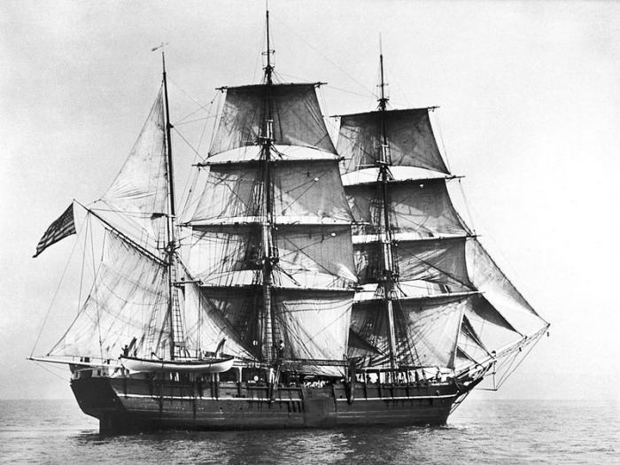 The starboard side of the Charles W. Morgan while she was under sail with a whaleboat on the davits.