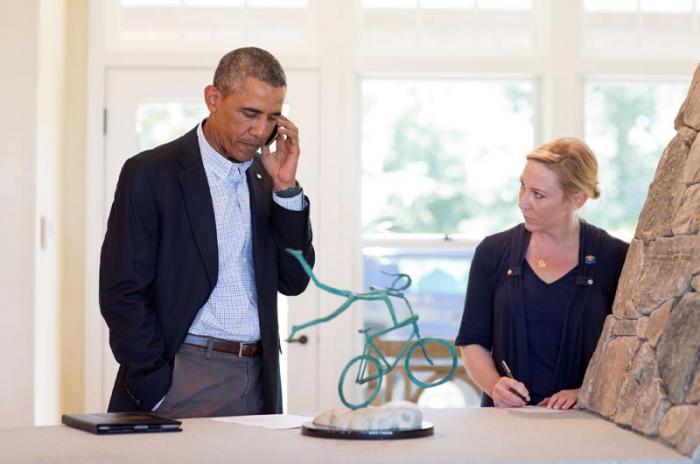 President speaks to Missouri governor by telephone from his summer home in Chilmark, gazing at Jay Lagemann sculpture.