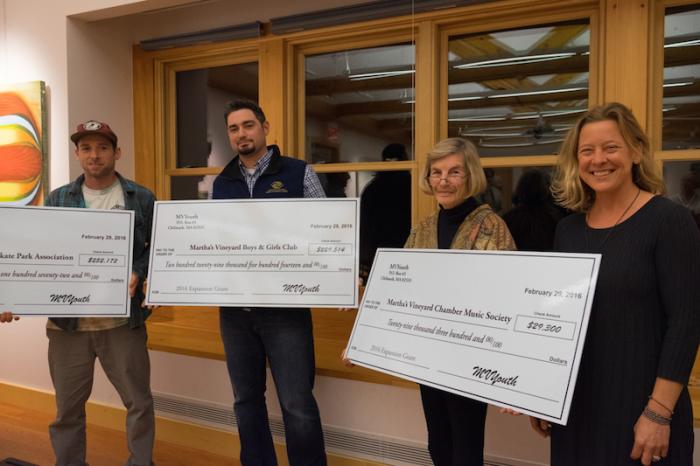 Grant recipients receive their checks: from left, skate park president Nick Briggs, Boys & Girls club director Peter Lambos, Nora Nevin for the chamber music society, MVYouth executive director Lindsey Scott.