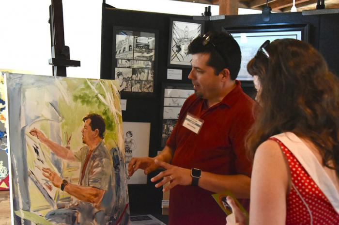 Many of the acrylic portraits, like painting of Dan Cooney, depict the artists at work in their studios.