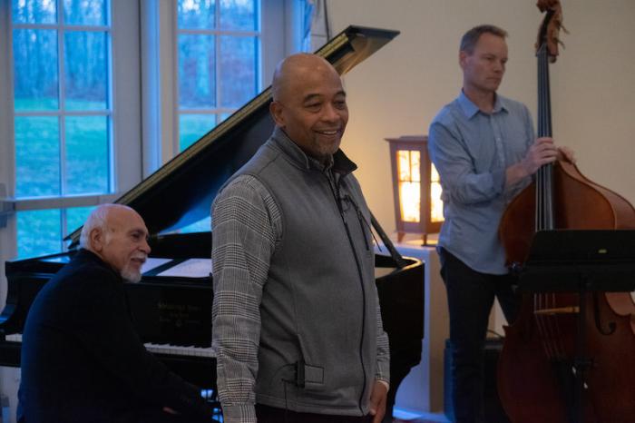 Lorna's husband Ken Armstead welcomes the audience, while John Alaimo and Eric Johnson get ready for the first number.