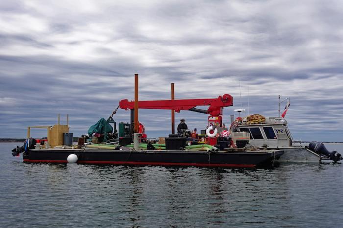 Recovery effort was conducted from a barge at Cape Pogue Pond early this summer.