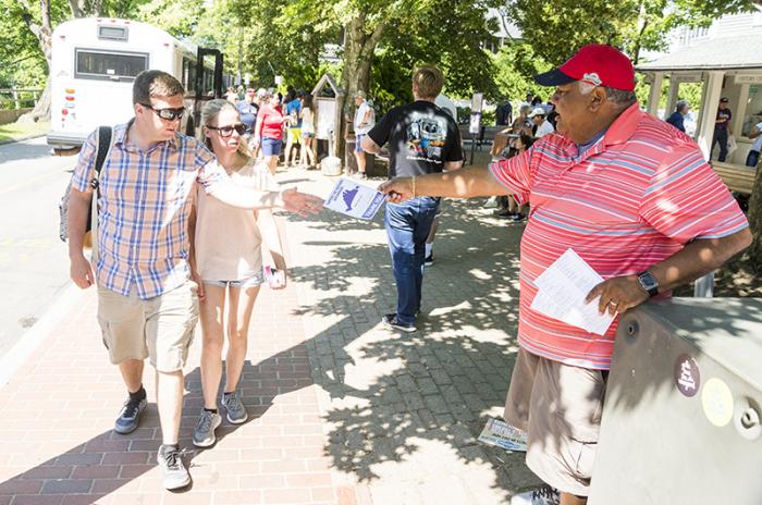 Striking driver Rich Michelson hands out leaflets to passing tourists on Church street in Edgartown.