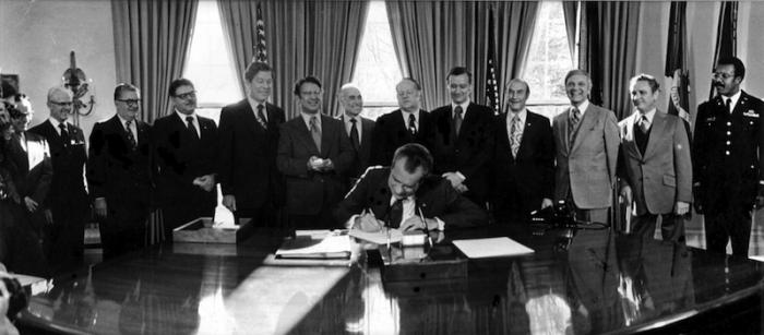 President Nixon signing a document to grant compensation to Brownsville veterans and their widows (William Baker far right).
