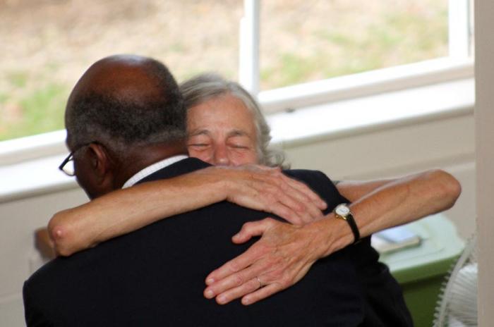Mr. Jordan gives Lucy Hackney a hug after medal ceremony for Sheldon Hackney at the Old Whaling Church, 2013.