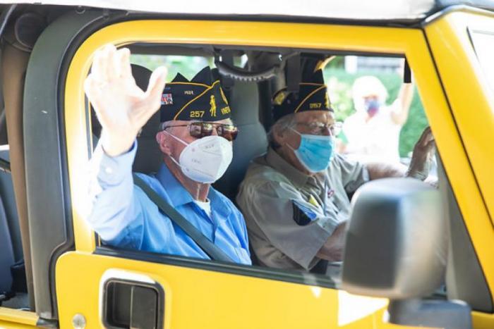 Mr. Foster behind the wheel for his impromptu July 4 parade last summer, with his friend and fellow veteran Bob Falkenburg.