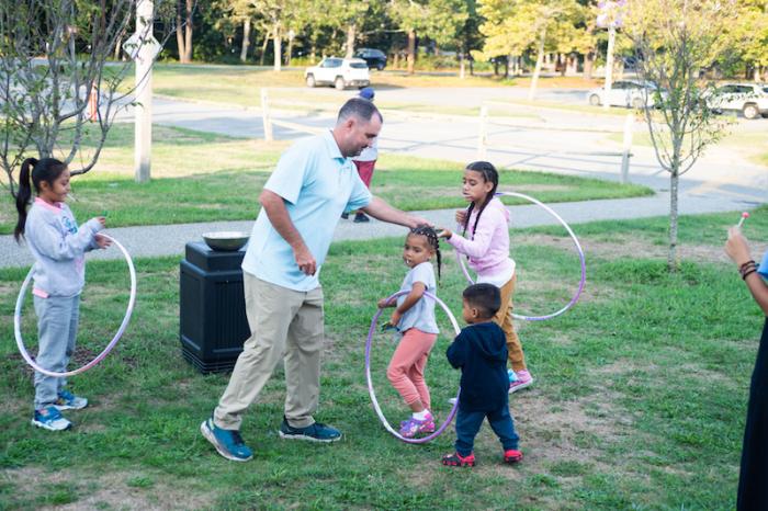 Assistant principal Jeremy Light helps provide a moment of normalcy outside the regional high school.