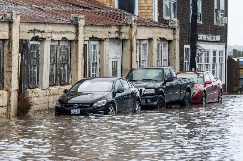 Vehicles parked on Beach Street Extension must contend with high water.