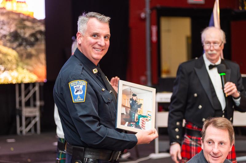 Edgartown Police Chief Bruce McNamee is presented with a picture of himself playing the bagpipes.