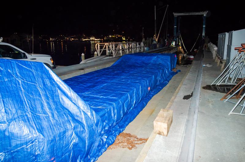 A tarp-covered truck bed waits for the whale.