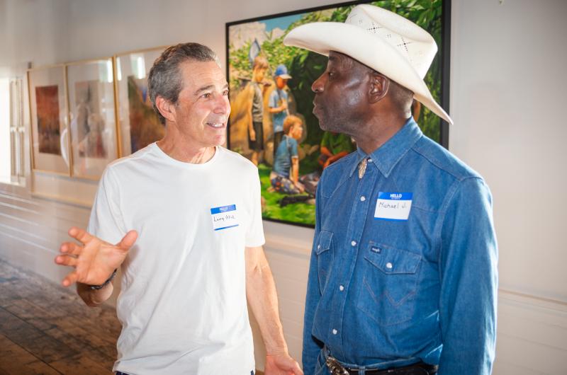 Photographers Larry Glick and Michale Johnson converse.