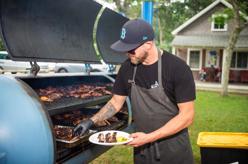 Tyler Potter of The Swimming Pig making barbecue.