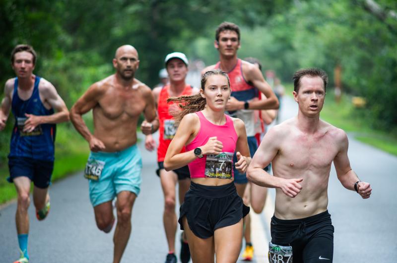 Lilly Tuck (center) was the first woman to cross the line.