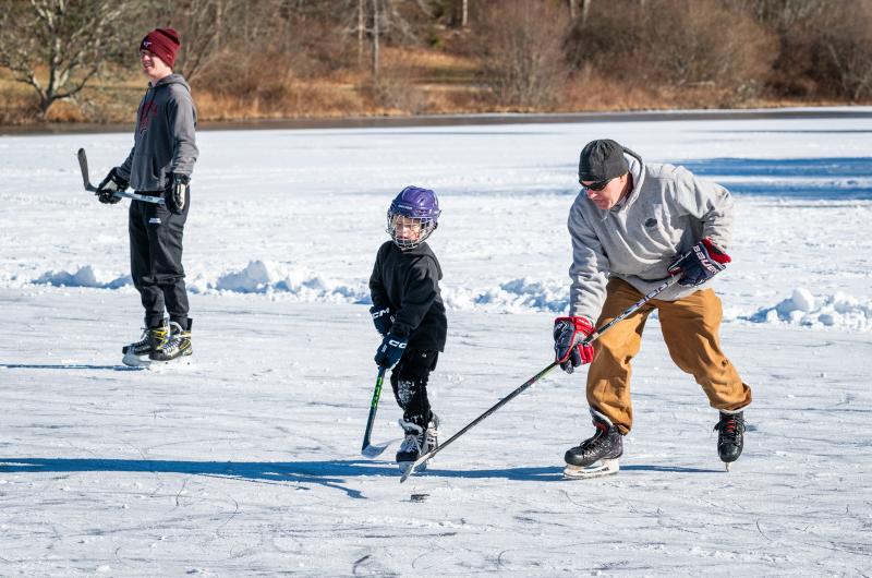 Jason Gale (right) shows younger players how it's done.