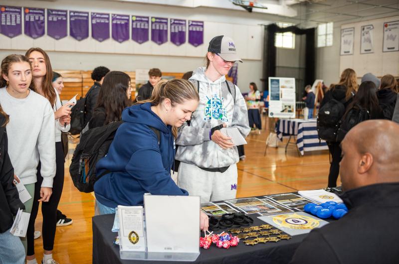 Students take materials from the Dukes County Sheriff's Office booth.
