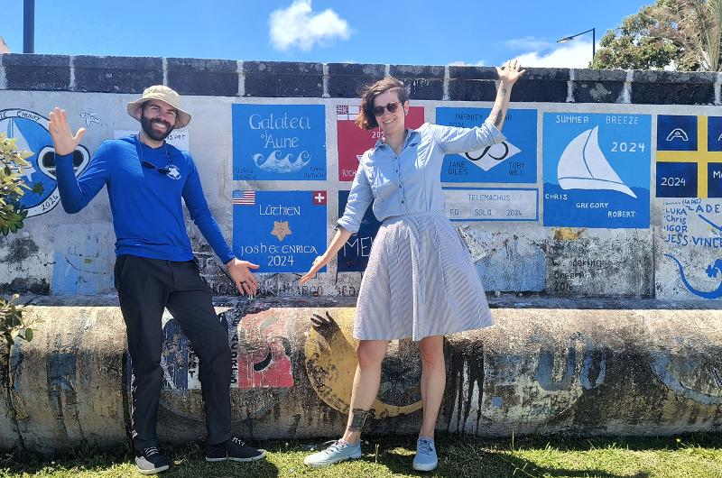 Josh Kegan and Enrica Jossi paint their sign on Horta in the Azores.